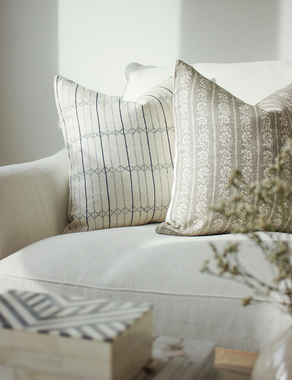 Styled image showing the Serena scatter cushion on a white sofa.