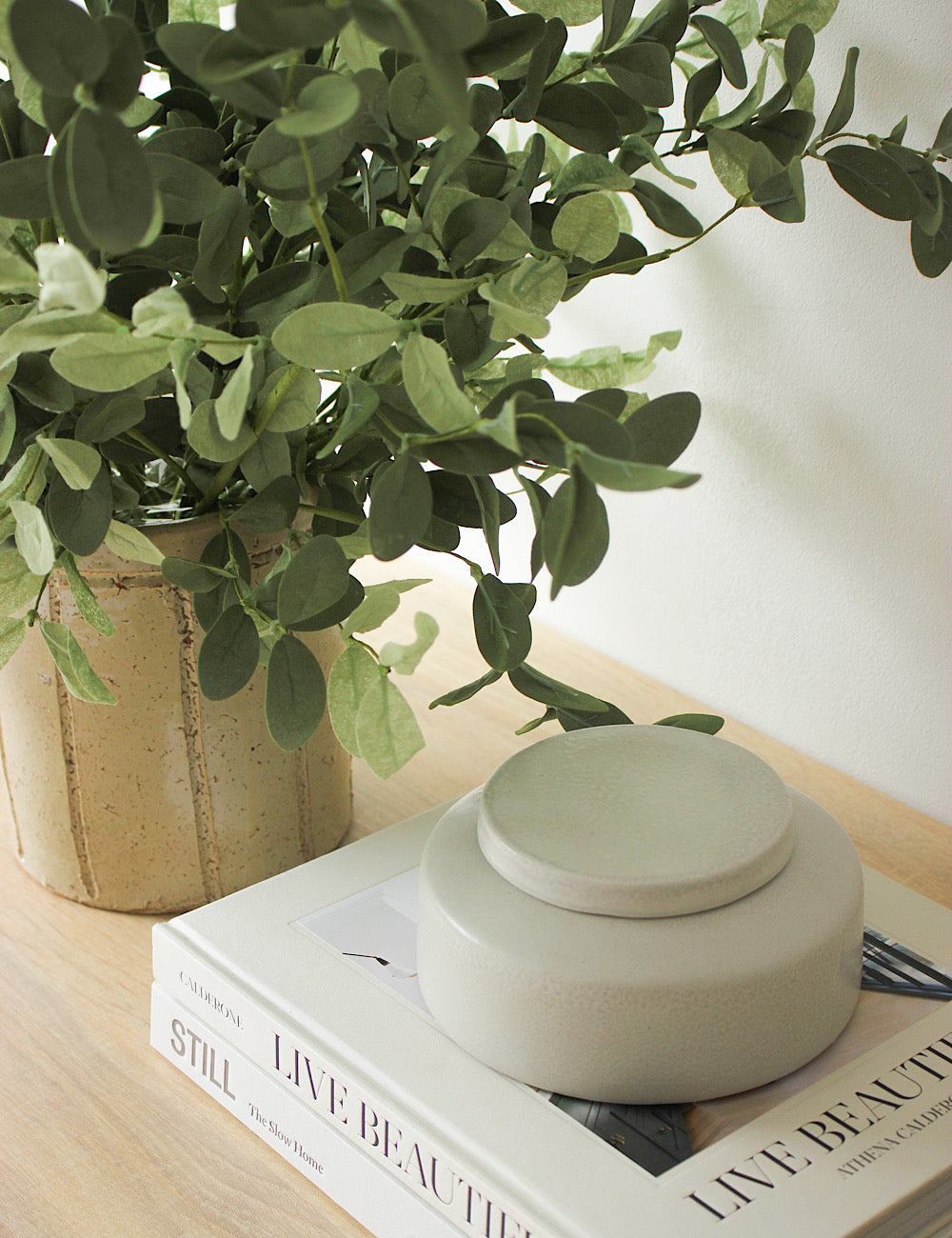 ceramic jar on stacked books.