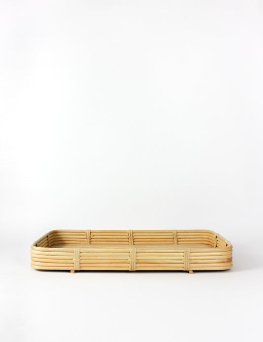 Side shot of a rectangular bamboo tray on a plain background.