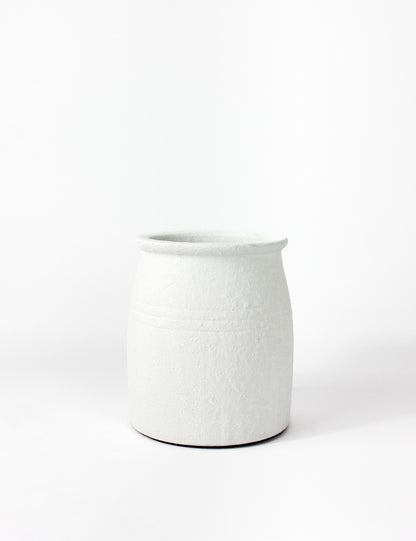 White terracotta pot with a textured finish and a bottle neck top. Cylindrical in shape.