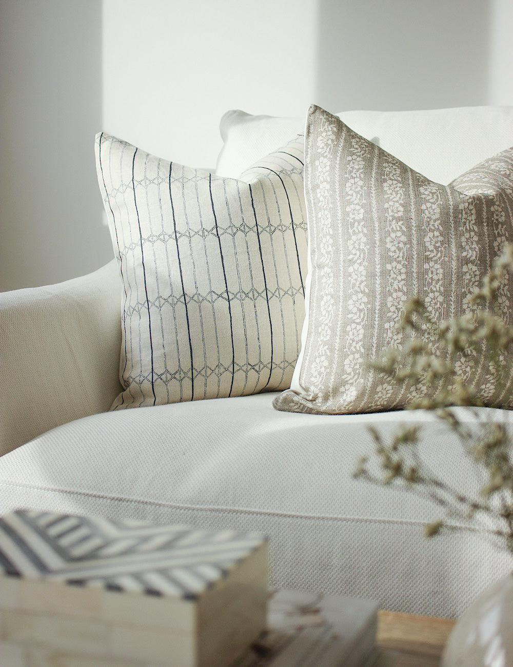 Styled image showing the Serena scatter cushion on a white sofa. 