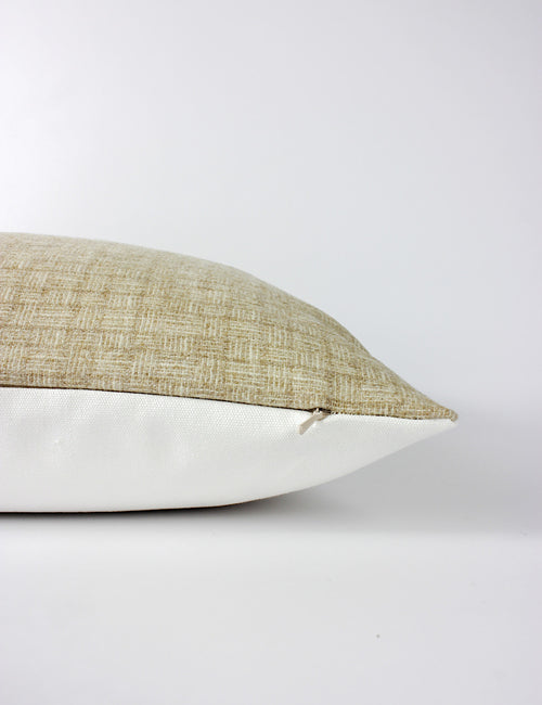 Side view of a neutral toned scatter cushion with a subtle small scale woven pattern across the front and a plain white back. Hidden zip. 