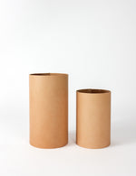 The back side of the two leather wrapped vases, one small, one medium.