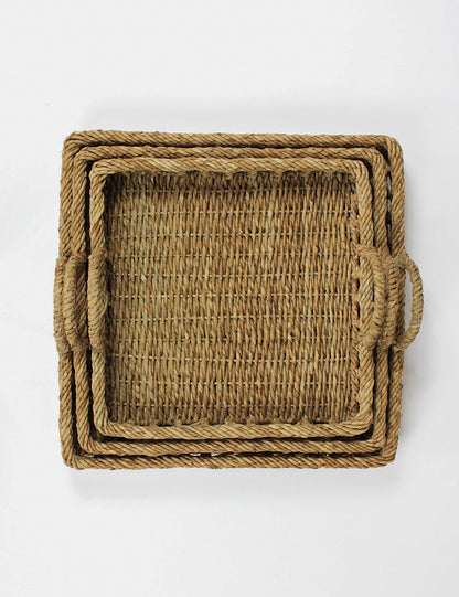 Top shot of three square rattan trays nestled within each other. 
