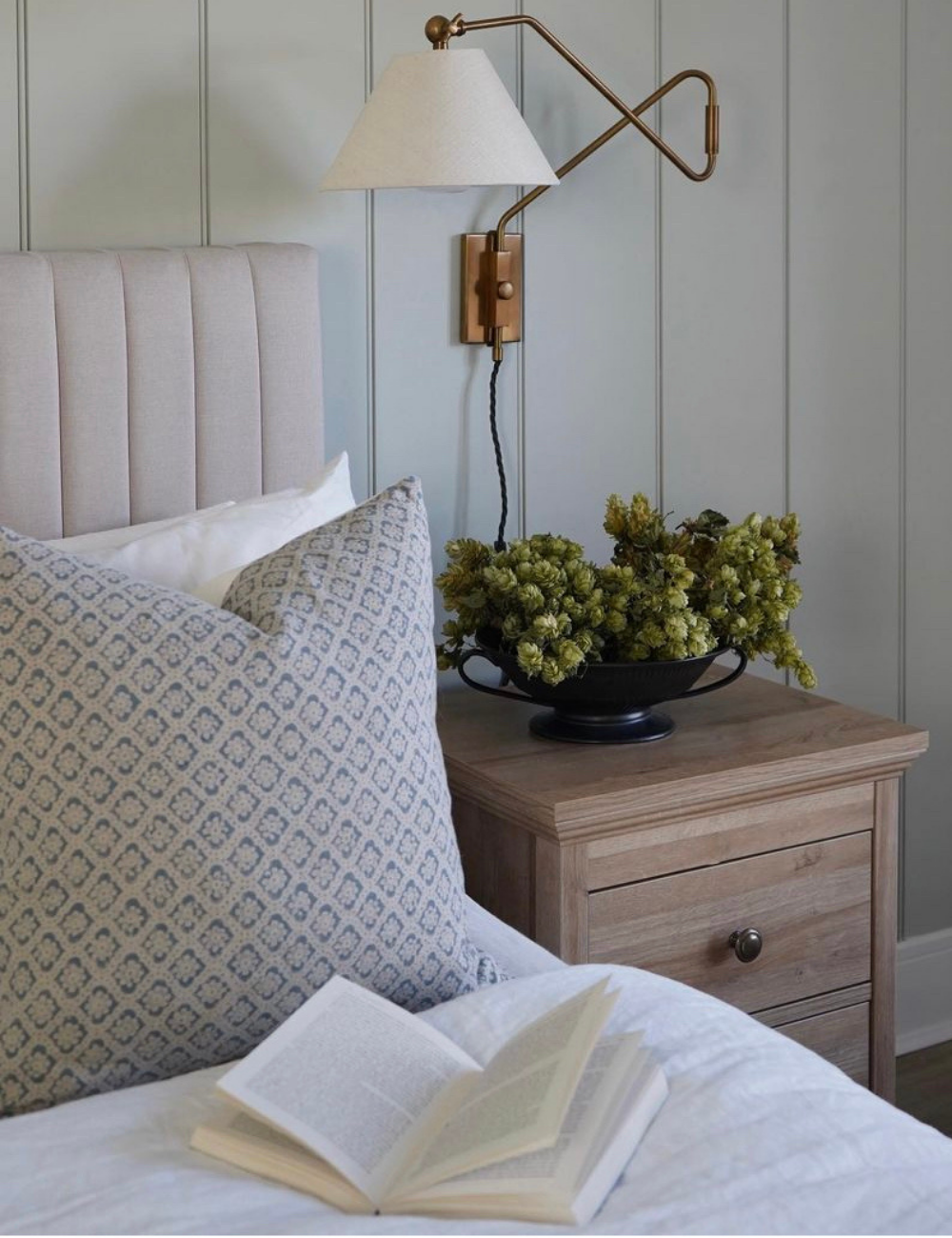 Styled image showing the Lana blue cushion cover on a bed.